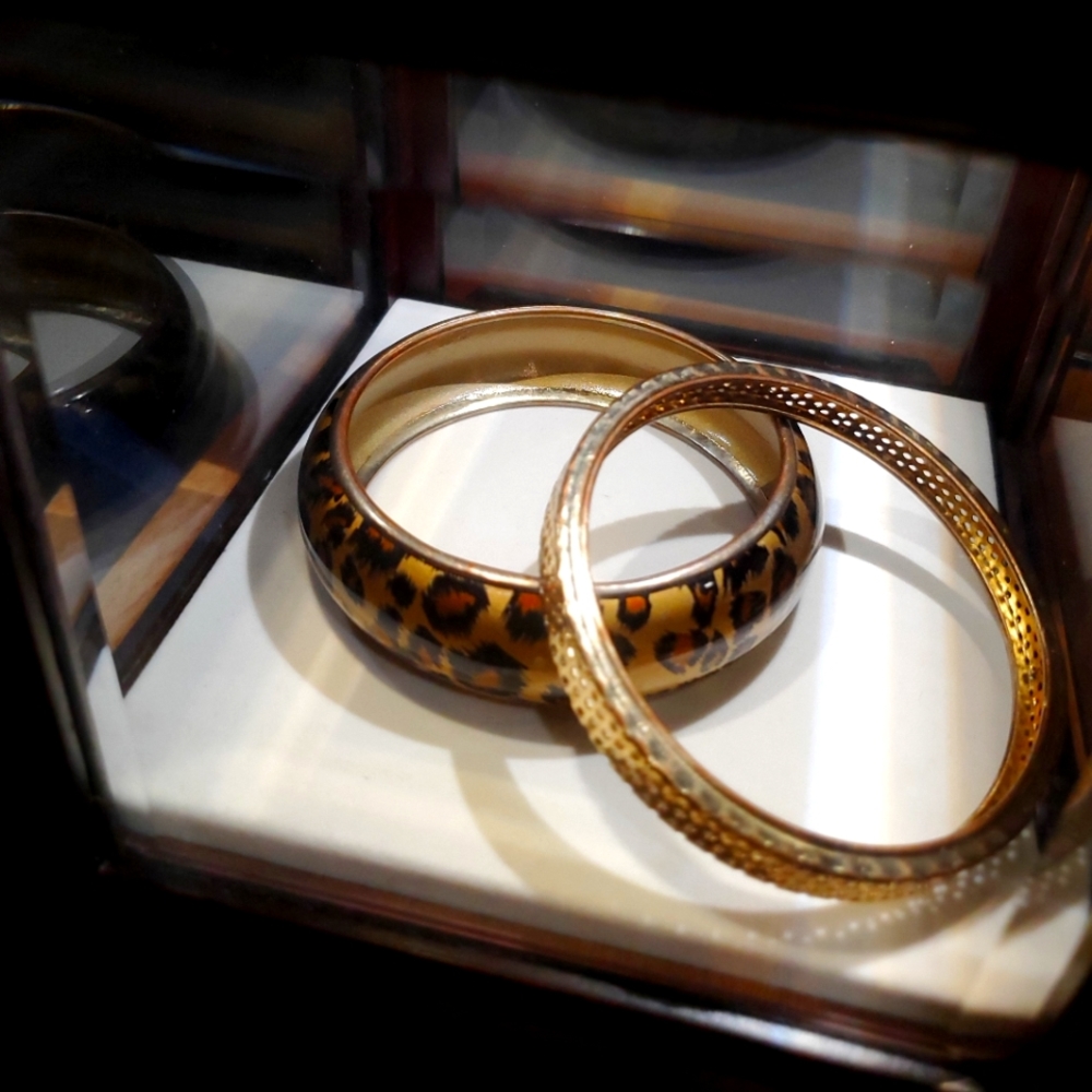 Two (2) brass bangle bracelets! One animal print and the other textured holes